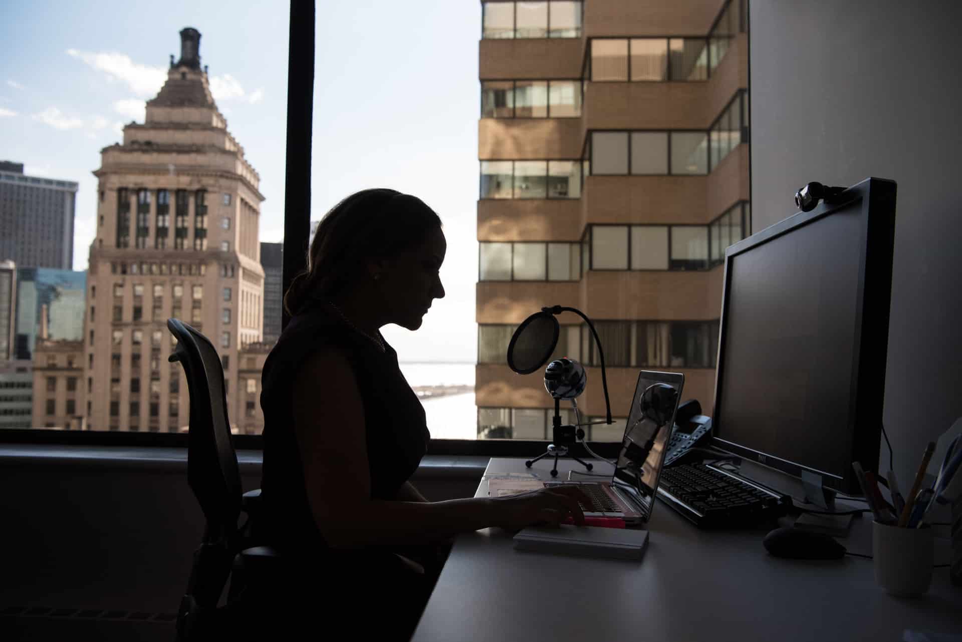 Woman working on laptop at a digital marketing agency planning SEO and social media marketing strategies